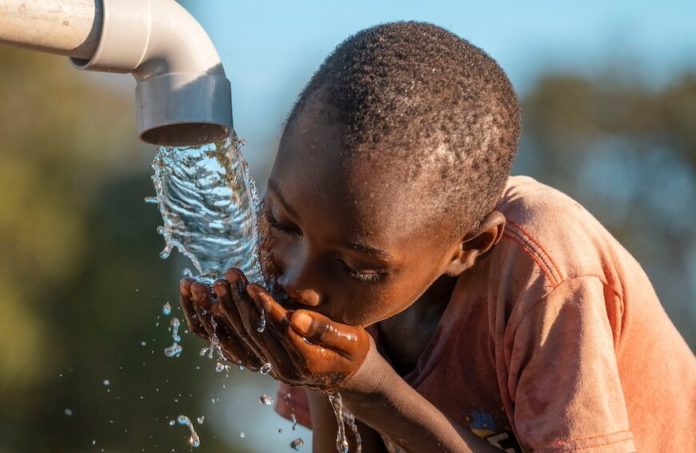 Mali,kenya,-,Agust,23,2021:happy,Boy,Drinking,Water,From,Water